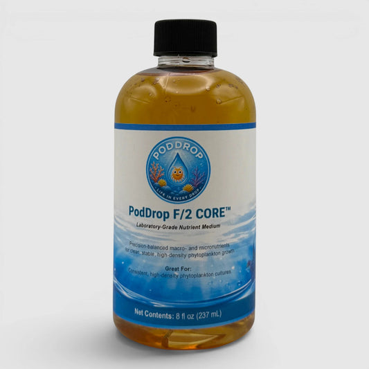 PodDrop F/2 CORE Laboratory-Grade Nutrient Medium for phytoplankton cultures. Amber liquid in a clear bottle.